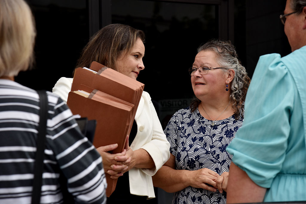 Lawyer Gaylin Carver, left, talks with Susan Wilson about the trial that day and actions moving forward